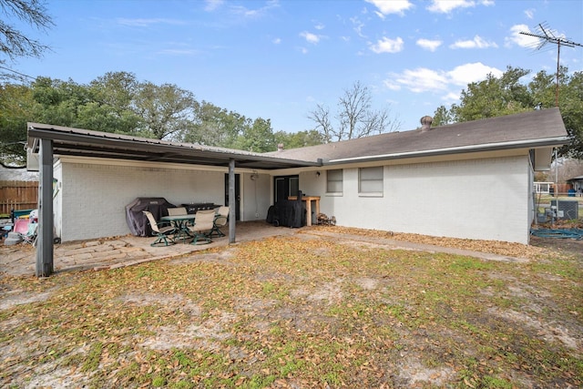 rear view of property featuring central AC and a patio