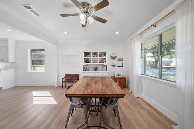 dining area featuring crown molding, ceiling fan, and light hardwood / wood-style floors