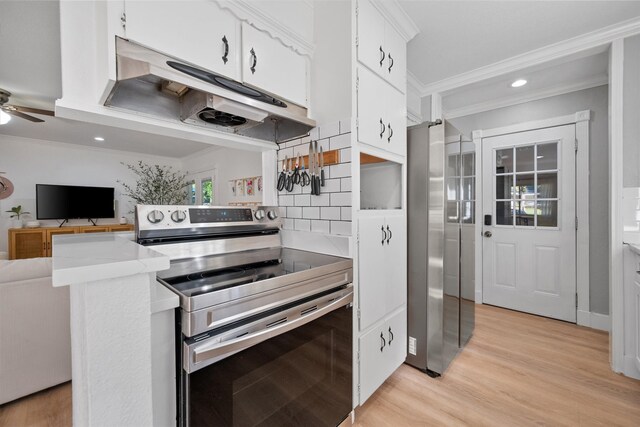 kitchen with crown molding, white cabinetry, stainless steel appliances, tasteful backsplash, and light wood-type flooring