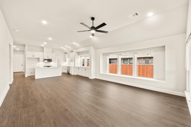 unfurnished living room with lofted ceiling, dark wood-type flooring, and ceiling fan