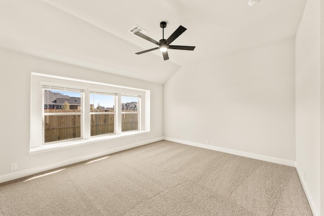 carpeted spare room with vaulted ceiling and ceiling fan