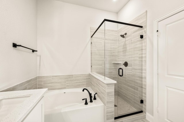 bathroom featuring vanity and separate shower and tub