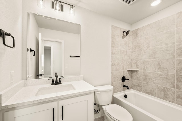 full bathroom with vanity, toilet, and tiled shower / bath combo