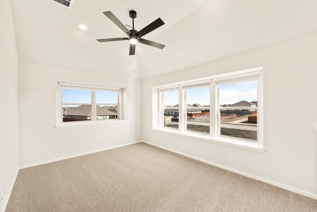 carpeted empty room with lofted ceiling and ceiling fan