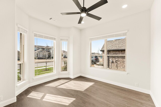 kitchen with light stone counters, light hardwood / wood-style floors, lofted ceiling, a kitchen island, and appliances with stainless steel finishes