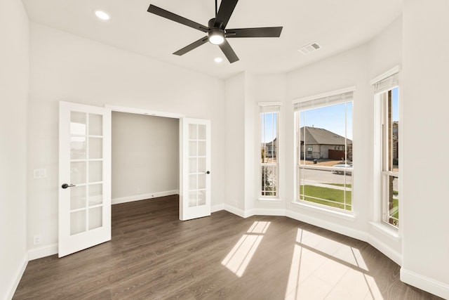 unfurnished room featuring dark wood-type flooring, ceiling fan, and french doors