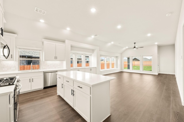 kitchen featuring stainless steel appliances, a center island, sink, and white cabinets