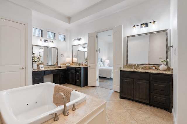 bathroom featuring tile patterned flooring, vanity, and a bath