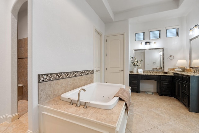 bathroom featuring a washtub, vanity, and tile patterned floors