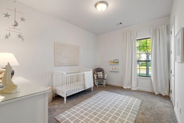 bedroom featuring carpet flooring and a crib