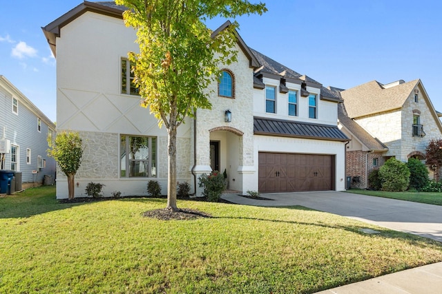 view of front of property featuring a standing seam roof, metal roof, concrete driveway, a front yard, and a garage