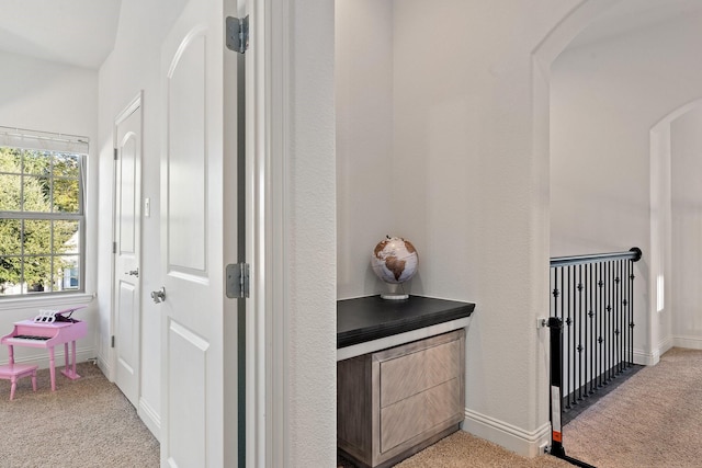 hall featuring light colored carpet