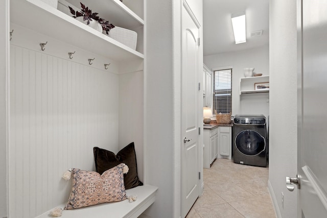 mudroom with washer / dryer and light tile patterned floors