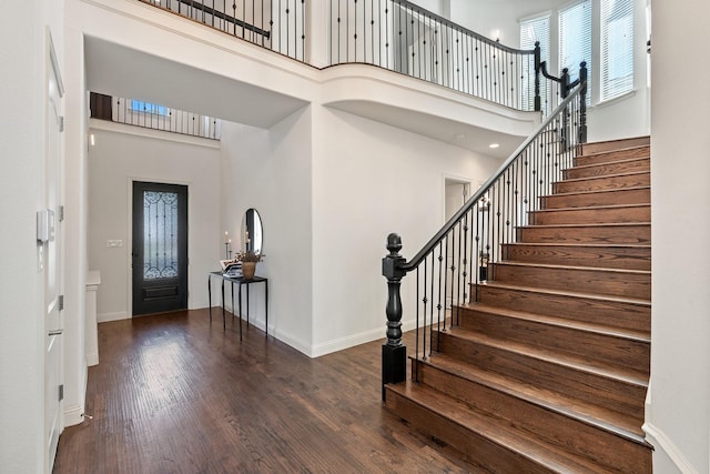 foyer featuring dark hardwood / wood-style flooring and a high ceiling