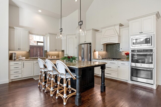 dining area featuring dark hardwood / wood-style floors and high vaulted ceiling