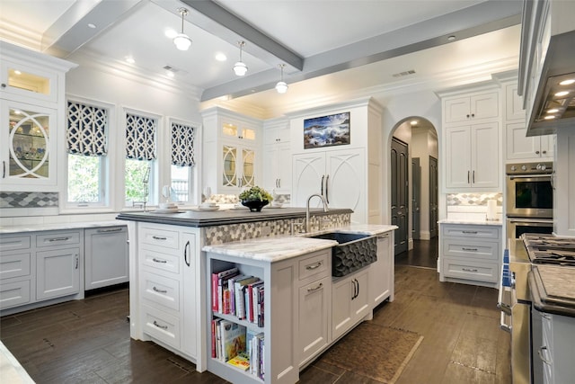 2009 E Highland St, Southlake, TX 76092 - kitchen with a sink, crown molding, an island with sink, dark wood finished floors, and backsplash