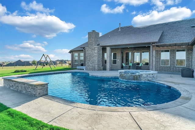 view of pool with a patio area and an in ground hot tub