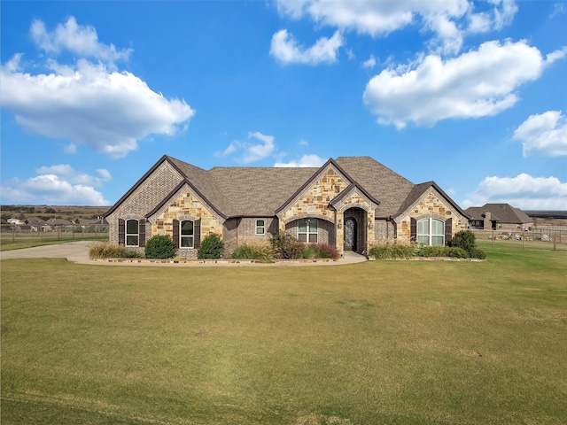 french country style house with a front yard