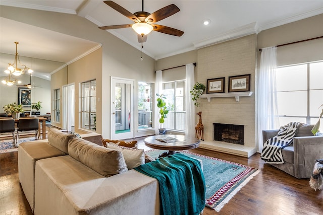 living room featuring ceiling fan, ornamental molding, a fireplace, and dark wood-type flooring