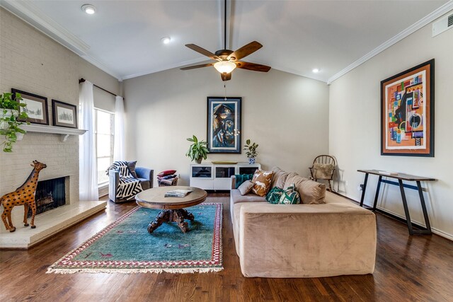 living room featuring ceiling fan with notable chandelier, dark hardwood / wood-style floors, lofted ceiling, and ornamental molding