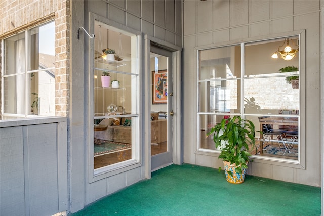 unfurnished sunroom with a notable chandelier