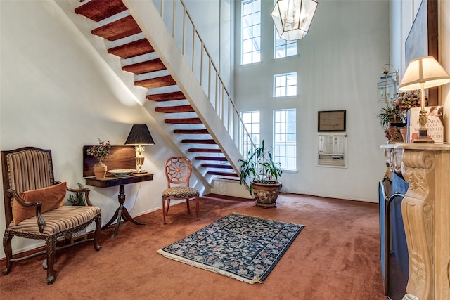 carpeted foyer with a high ceiling