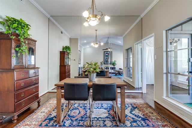 dining area featuring lofted ceiling, a wealth of natural light, dark wood-type flooring, and ceiling fan with notable chandelier