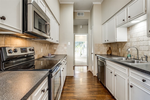 kitchen featuring backsplash, white cabinetry, sink, and appliances with stainless steel finishes