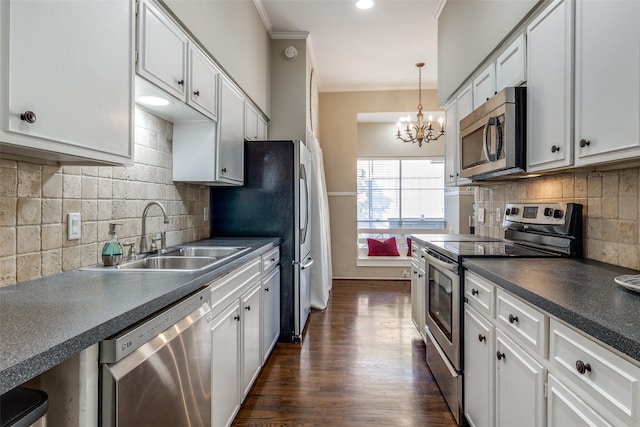 kitchen with backsplash, white cabinetry, an inviting chandelier, and appliances with stainless steel finishes