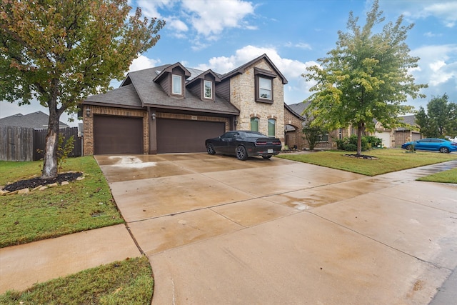 view of front of house with a garage and a front lawn