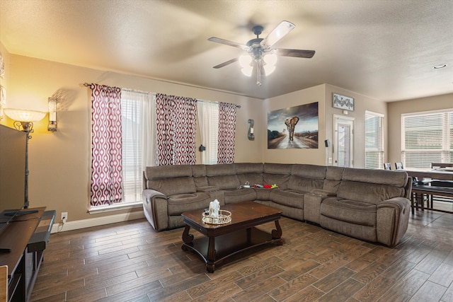 living room featuring a wealth of natural light, dark hardwood / wood-style flooring, ceiling fan, and a textured ceiling