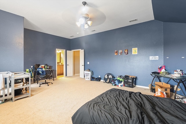 carpeted bedroom featuring connected bathroom, ceiling fan, and lofted ceiling