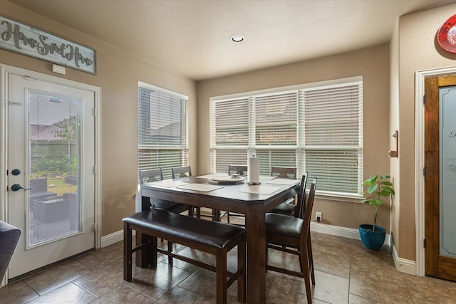 dining area featuring tile patterned flooring