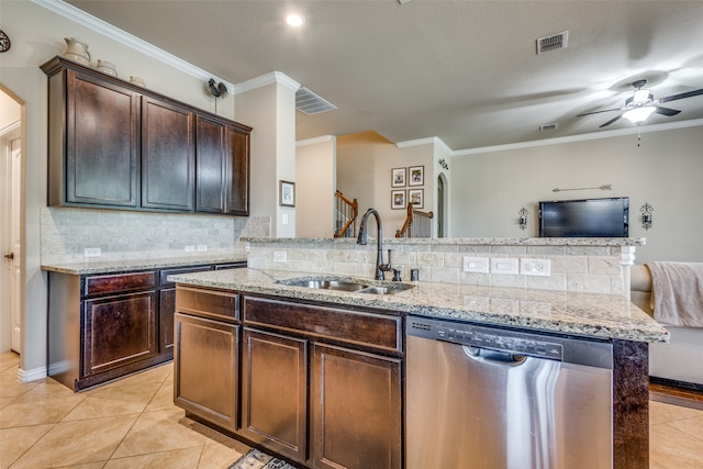 kitchen with backsplash, ornamental molding, sink, dishwasher, and a kitchen island