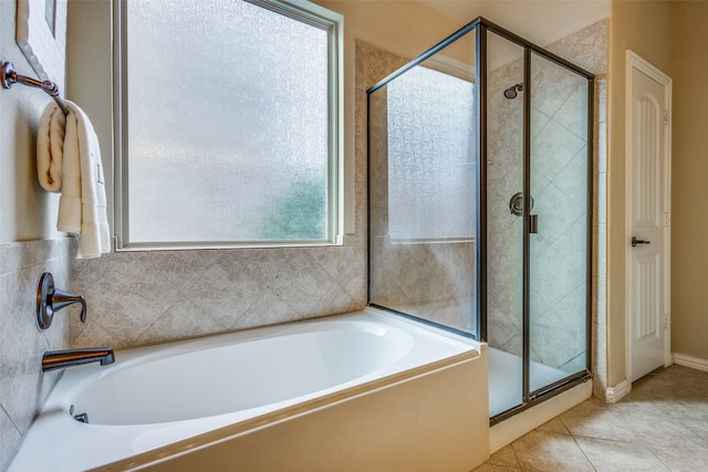 bathroom featuring tile patterned flooring and independent shower and bath