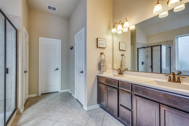 bathroom with tile patterned floors, vanity, and a shower with shower door