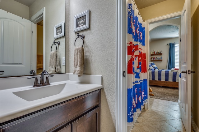 bathroom featuring tile patterned floors, vanity, and a textured ceiling