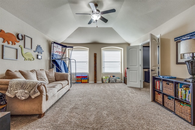 carpeted living room featuring a textured ceiling, ceiling fan, and lofted ceiling