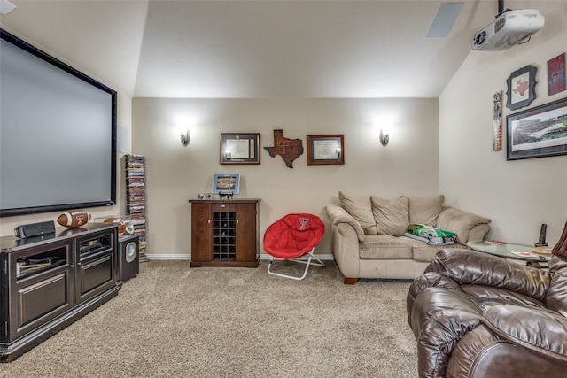 cinema with light colored carpet and vaulted ceiling