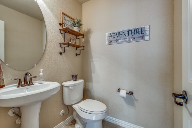 bathroom with toilet and sink