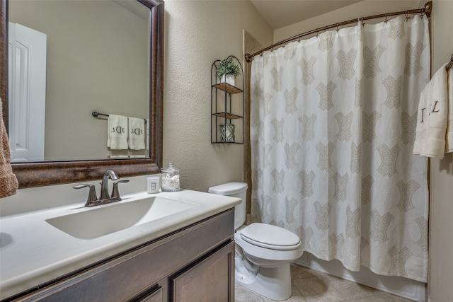 bathroom with tile patterned flooring, vanity, and toilet