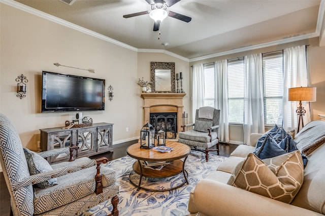 living room featuring hardwood / wood-style floors, ceiling fan, ornamental molding, and vaulted ceiling