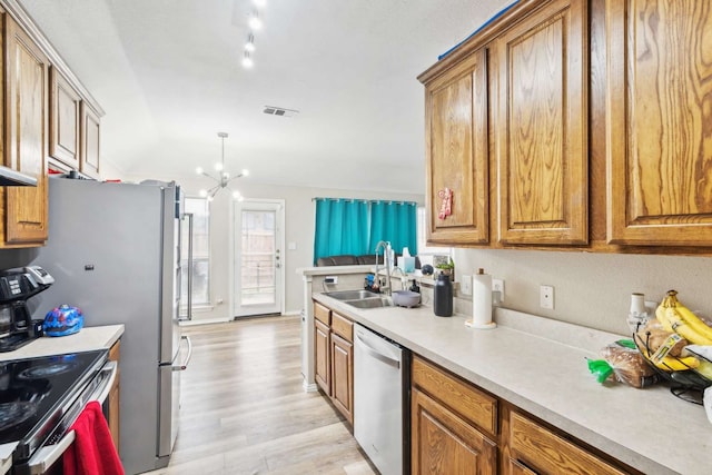 kitchen featuring stainless steel dishwasher, white range with electric stovetop, sink, a notable chandelier, and light hardwood / wood-style floors