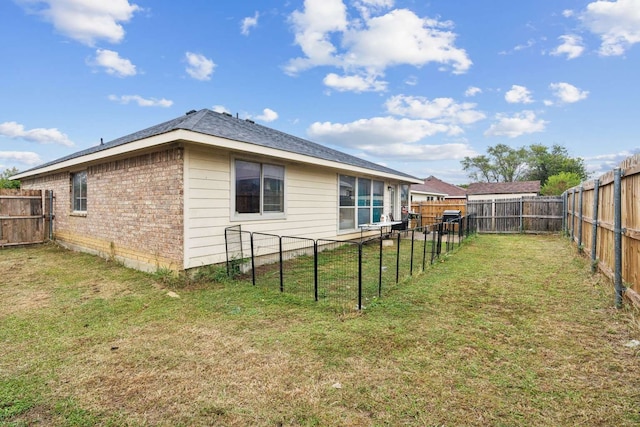 back of house with a lawn