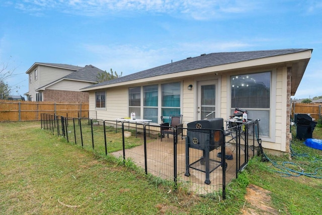 rear view of property featuring a yard