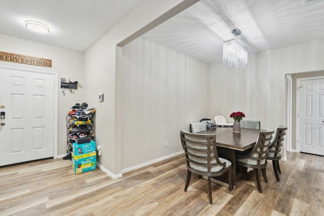 dining area featuring a chandelier and light hardwood / wood-style flooring