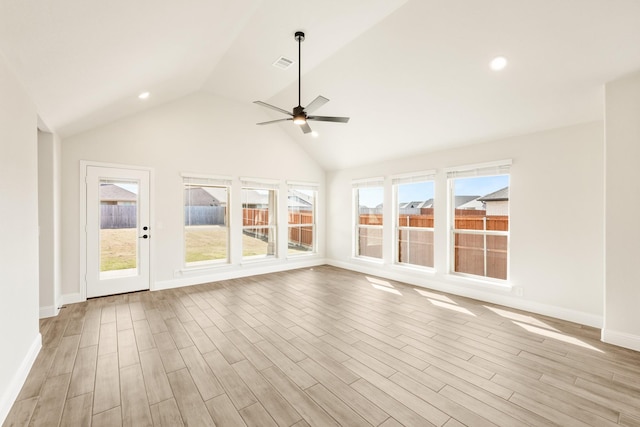 unfurnished sunroom featuring visible vents, vaulted ceiling, and ceiling fan