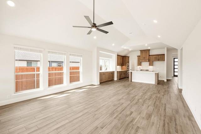 unfurnished living room with ceiling fan, recessed lighting, baseboards, and light wood-style floors