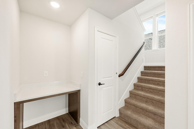 stairs featuring recessed lighting, baseboards, and wood finished floors