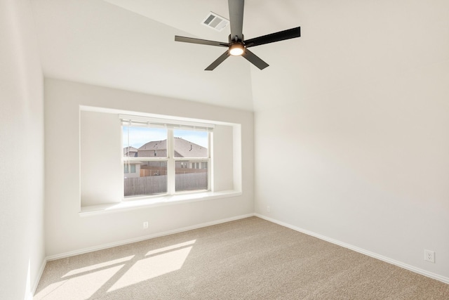 carpeted spare room featuring baseboards, visible vents, and a ceiling fan